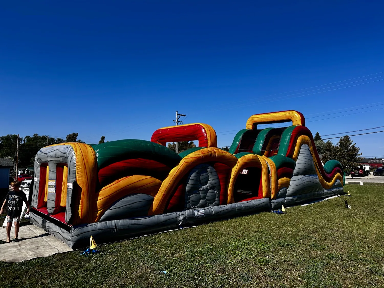 Giant inflatable obstacle course in the fenced field during the 2nd Annual Harvest Festival