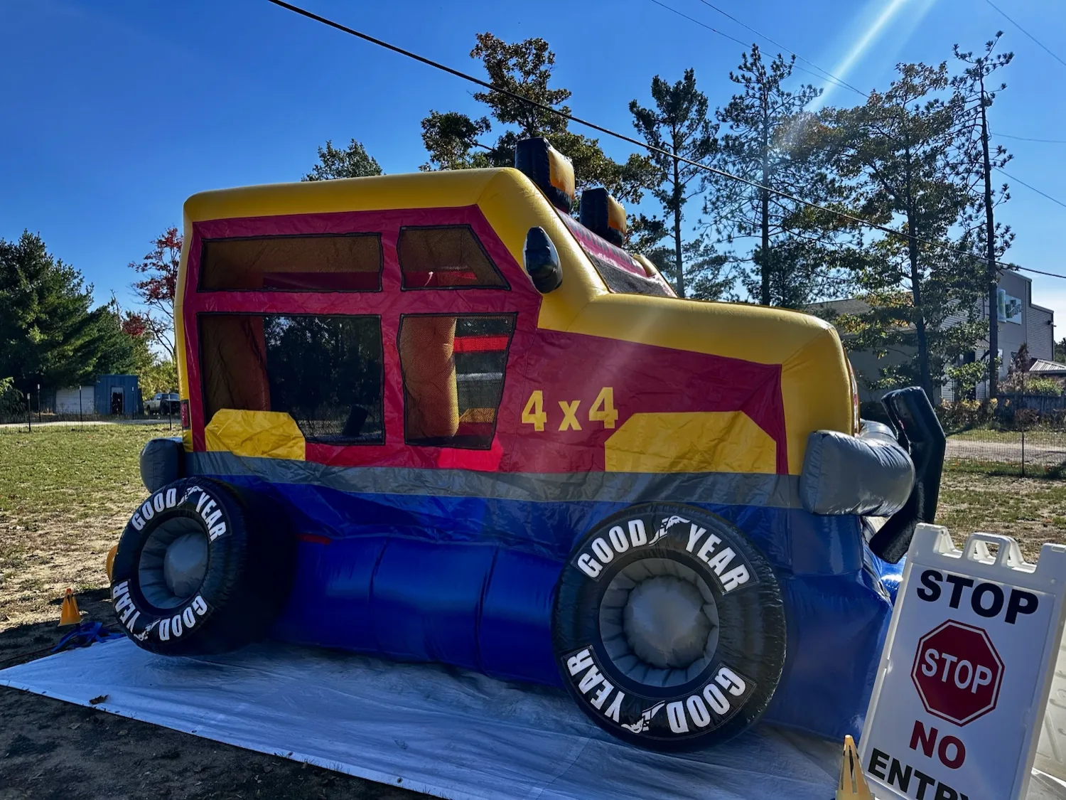 4x4 monster-truck inflatable bounce house in the fenced field on a sunny day during the 2nd Annual Harvest Festival